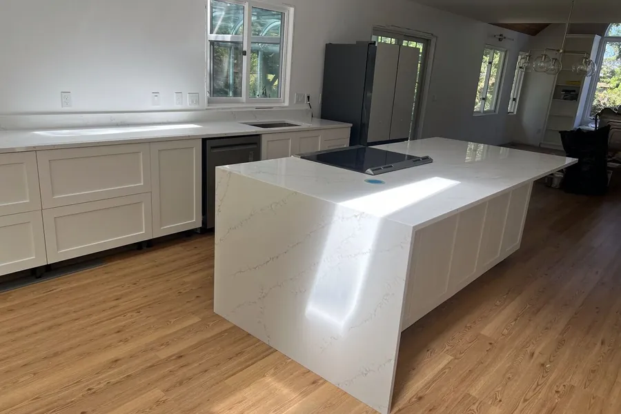 Waterfall end mitered from the same slab so the vein turns the corner