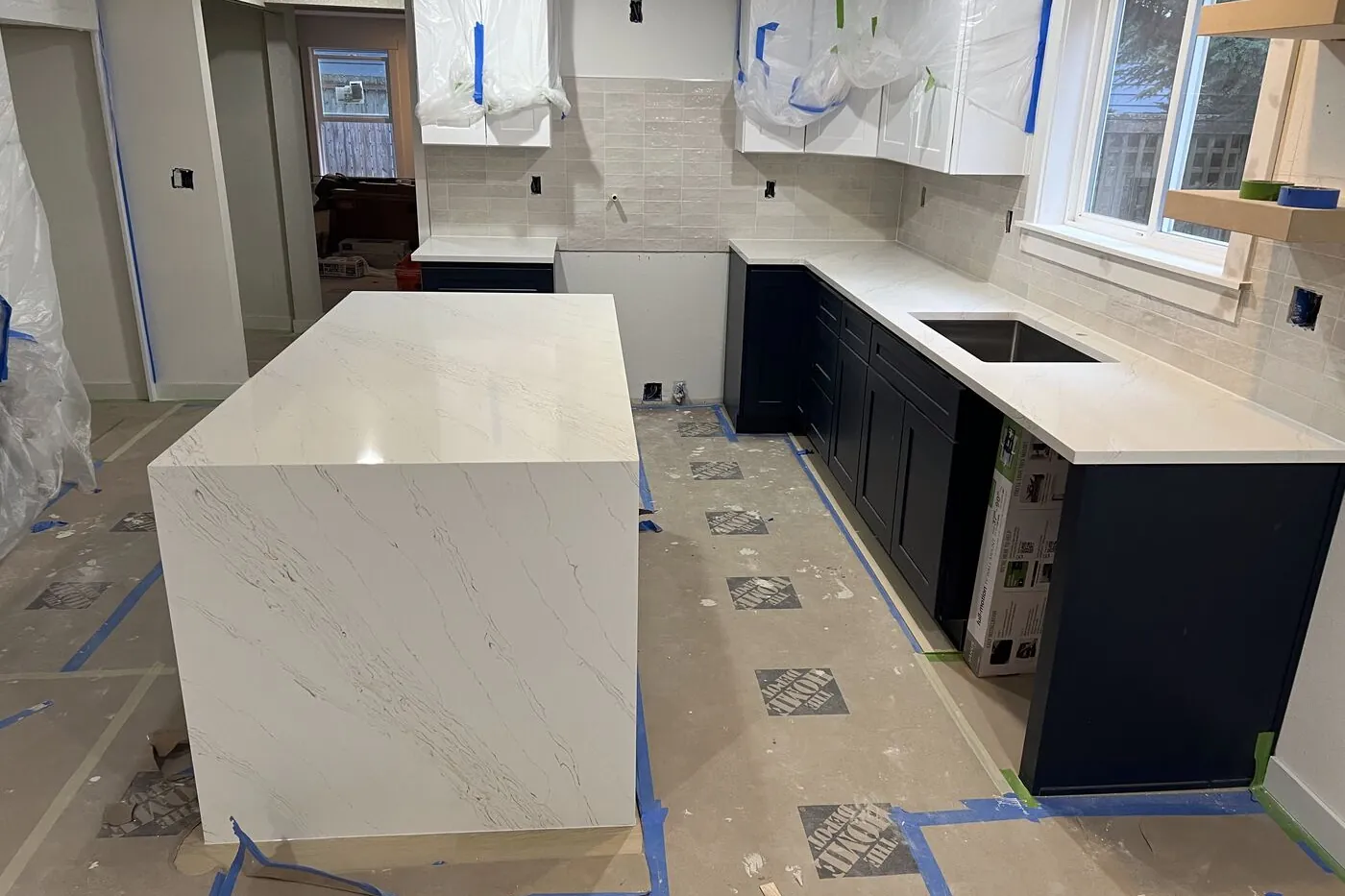 Waterfall end and full-height backsplash — both are named on the quote before you sign