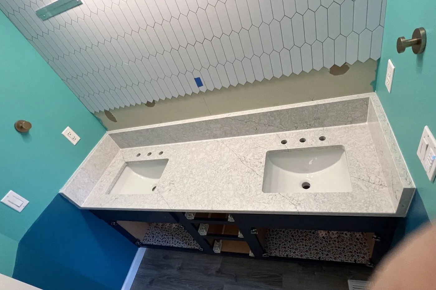 Bathroom vanity top installed against fresh tile