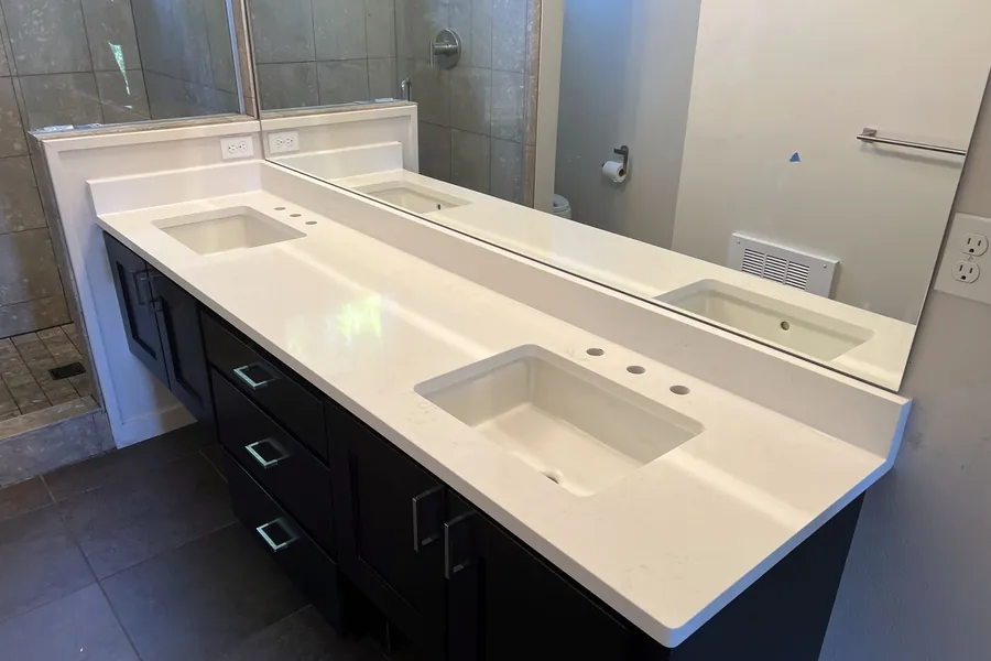 Double vanity, dark cabinets — the most common bathroom job we do