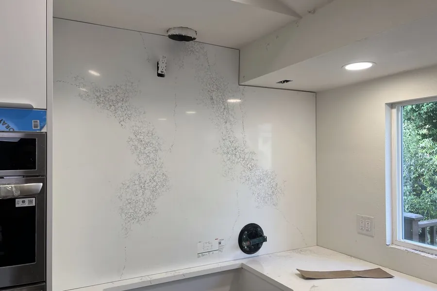 A full-height slab backsplash: fewer joints, and the ones left are planned