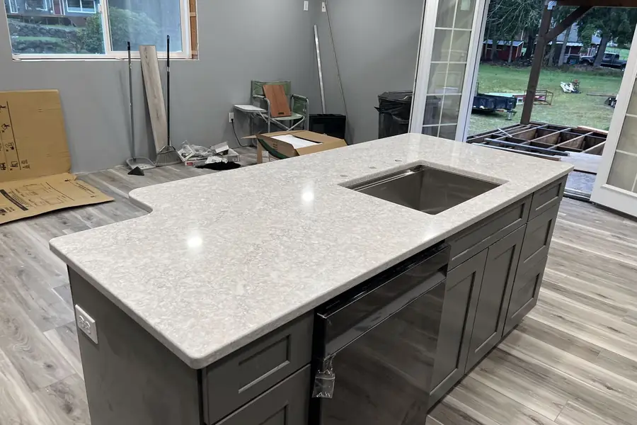 Undermount sink set into a stone countertop and supported from underneath
