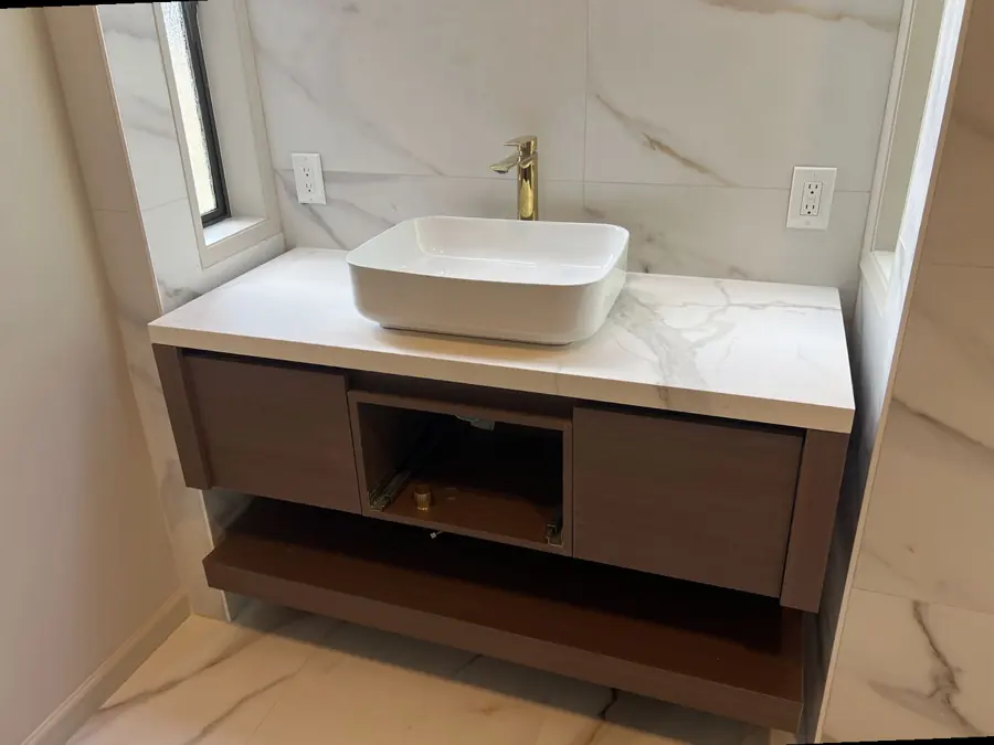 Stone vanity top with a vessel sink in a remodeled bathroom