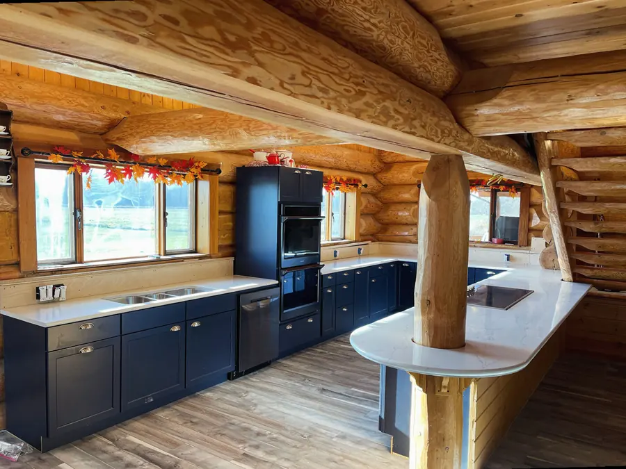 Curved countertop peninsula in a log home kitchen